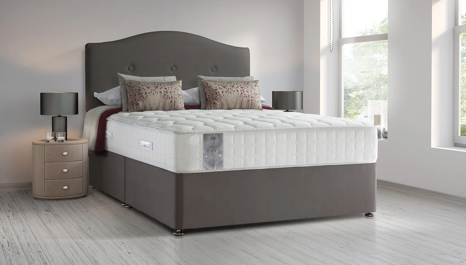 Grey upholstered bed and headboard in a restful bedroom